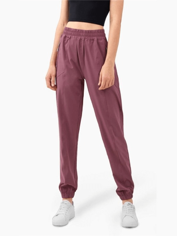 Purple high-waisted yoga training pants with drawstring closure, perfect for women seeking stylish comfort, shown on model without face.